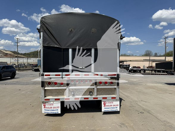 Reitnouer Big Bubba flatbed trailer rear view with a black canvas cover, taillights, and dual rear bumper. VIN 1RNF48A25NR055931 visible in listing context.