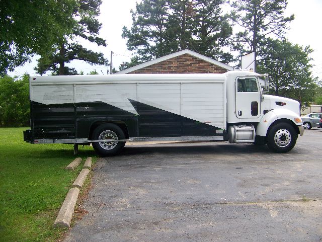 Peterbilt 335 box truck side view showing large white cargo box with black and gray graphics.