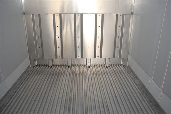 Interior of a CIMC refrigerated container trailer showing metal ribs and ribbed floor in a clean in-service condition.