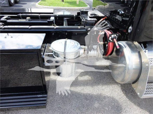 Peterbilt 337 chassis with fuel tank, air line hoses, and polished metal components visible on side of cab.