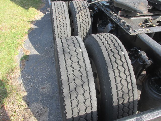 Truck rear dual tires and chassis components visible in a Freightliner Century truck; no legible labels or text clearly visible on components.