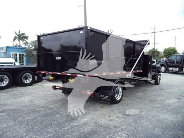 2023 Chevrolet Silverado 6500HD dumping trailer shown from rear/side with black dump bed and dual rear wheels.