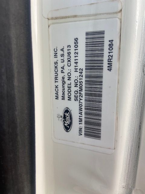 Mack Trucks label on door displaying Mack Trucks, Inc. Macungie, PA, U.S.A. Model No.: CXU613, VIN: 1M1AW07Y2FM051242, barcode beneath, sequence number H141121056, and 4MR21084.