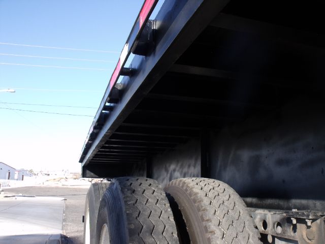 Rear undercarriage of a Fontaine flatbed expandable trailer showing tandem axles and underframe framing.