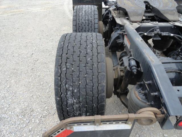 Rear view of a Freightliner Columbia truck chassis showing two dual rear tires, suspension components, and part of the frame.