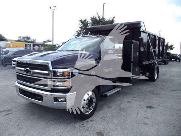 2023 Chevrolet Silverado 6500HD front and side view with dump bed in a dealership lot