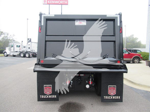 Kenworth T480 dump truck bed rear view with hydraulic lift, dual mud flaps labeled 'TruckWorks', stock number TM194093LM visible.