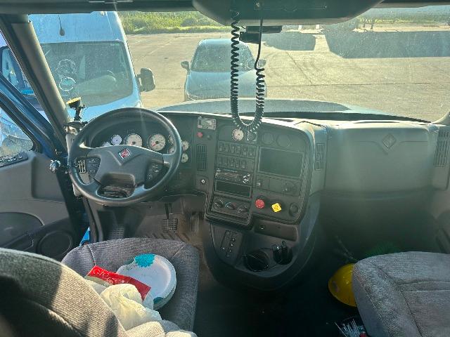 Truck cab interior of a 2017 International Prostar showing steering wheel, dashboard, and center console with gauges and controls.