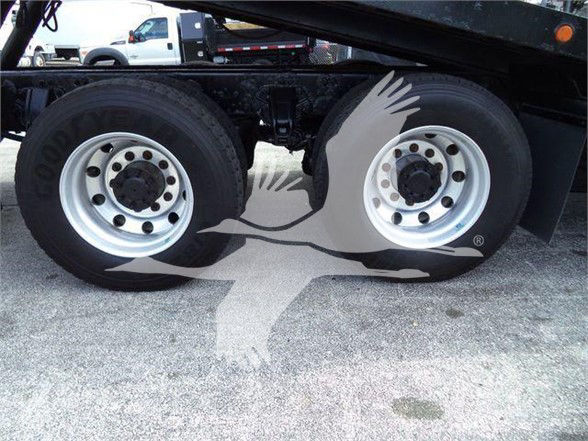 Peterbilt 367 wheel and dual rear axle visible, with stock number and VIN text partially visible in the listing.