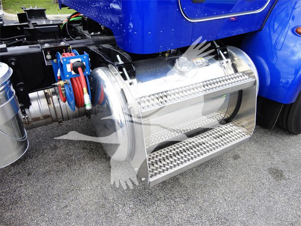 Peterbilt 337 truck side showing polished stainless steel fuel step with diamond plate tread and attached hoses; blue cab in background.