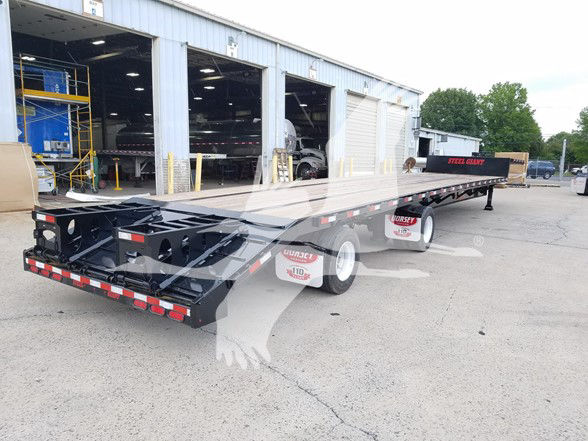 New 2026 Dorsey beavertail drop deck expandable trailer showing twin axles and open deck with rear hitch and reflective striping.