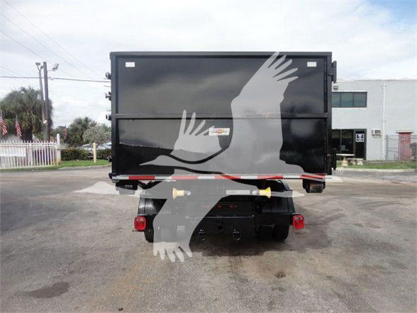 Back of a black Ram 5500 SLT hooklift truck with a large container, license plate area not visible, rear lights and hitch components visible.