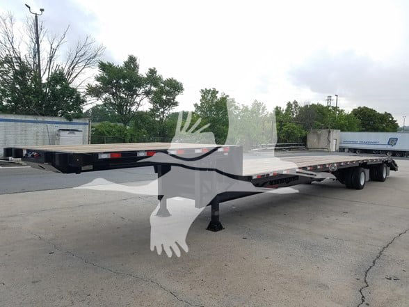 Dorsey Steel dropdeck beavertail trailer showing long flatbed with expandable sections and tandem rear axles.