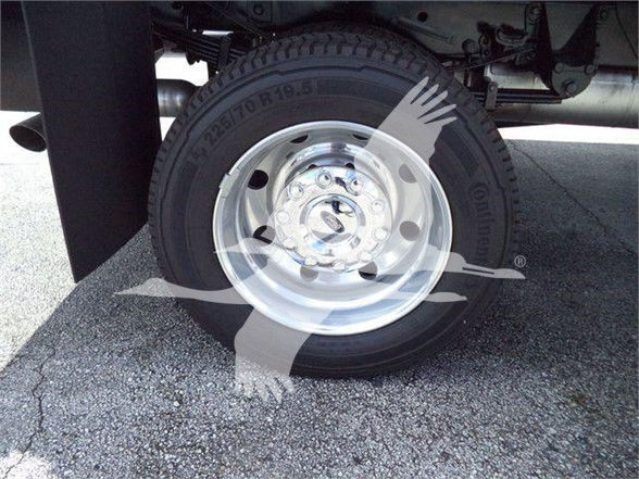 Front wheel of a 2022 Ford F550 with aluminum rim and tire, undercarriage visible.