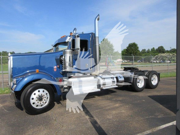 Kenworth W900L conventional daycab truck in blue, side view, showing dual rear axles and chrome exhaust stacks.