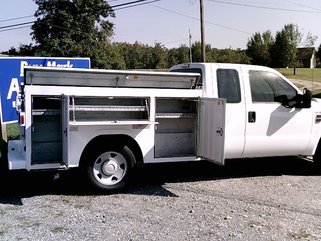 Service/utility truck with side storage compartments open showing multiple drawers and tool areas.