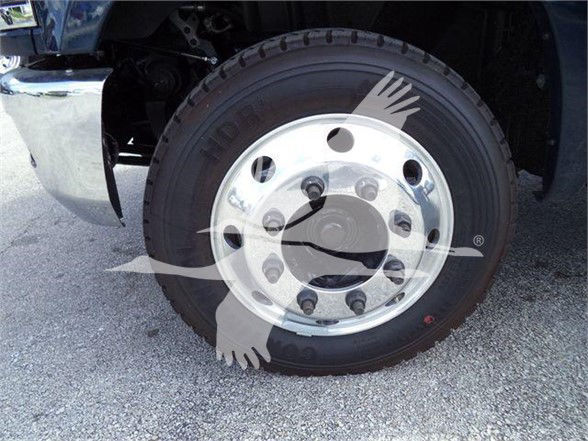 Chevrolet Silverado 6500HD front wheel showing heavy-duty steel rim and tire, with hub and lug nuts visible.