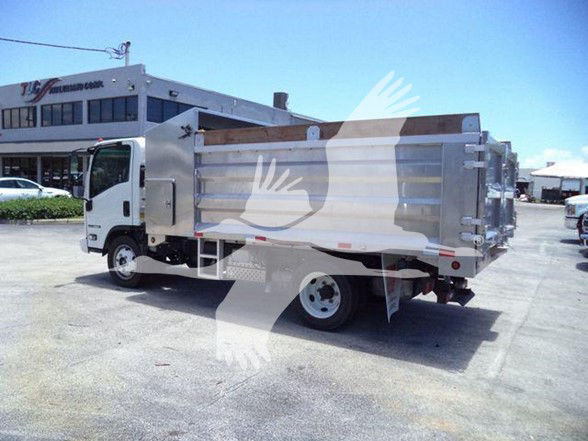 Isuzu NQR dump truck with aluminum cargo bed and dual rear wheels in a dealership lot.