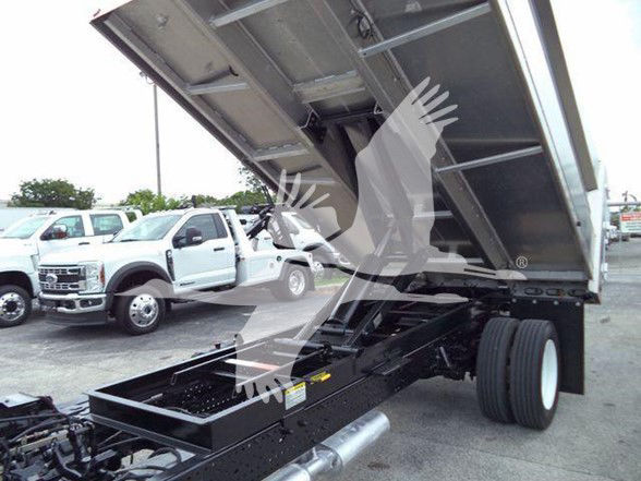 Isuzu NPR HD truck bed raised showing chassis and dual rear wheels with hydraulic lifting mechanism.
