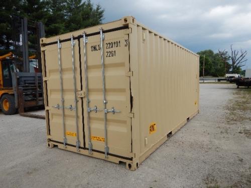 Shipping container with double doors at rear, tan color, with metal locking bars and identification numbers on doors.