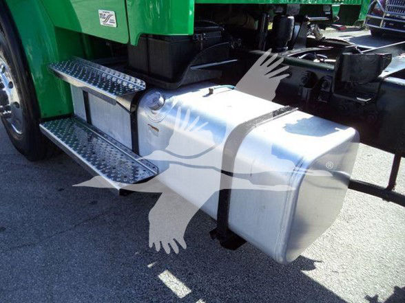 Truck side step, fuel tank, and steps on a Freightliner M2 cab. Visible metal fuel tank with twin diamond-plate steps and green cab in background.
