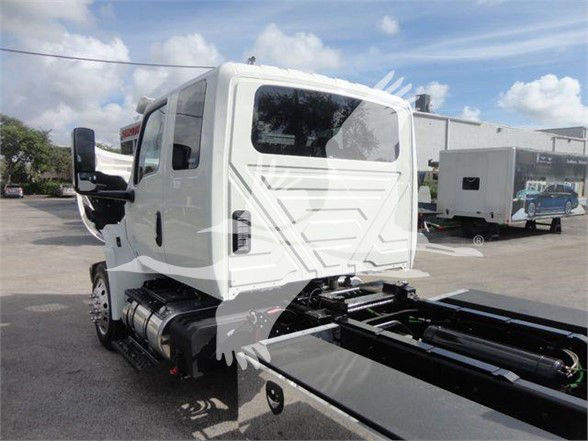 International MV cab with flatbed chassis showing side view mirror and rear cabin door.
