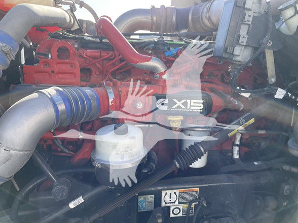 Kenworth T800 engine bay showing Cummins X15 badge and engine components.