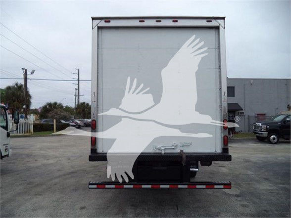 Ford E-450 box truck rear view showing blank rear doors, light bars, and bumper with reflective tape.