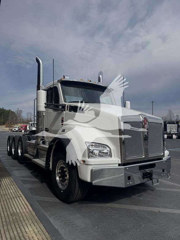 Kenworth T880 conventional daycab truck in white showing front grille, headlights, and dual exhaust stacks.
