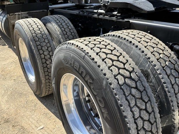 Truck rear wheels and dual tires of a 2021 International Lonestar showing JSHank or Hankook tire tread pattern.