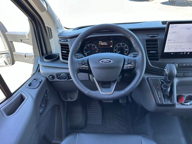 Ford Transit 350 dashboard and steering wheel with center display and gear selector in a box truck cab.