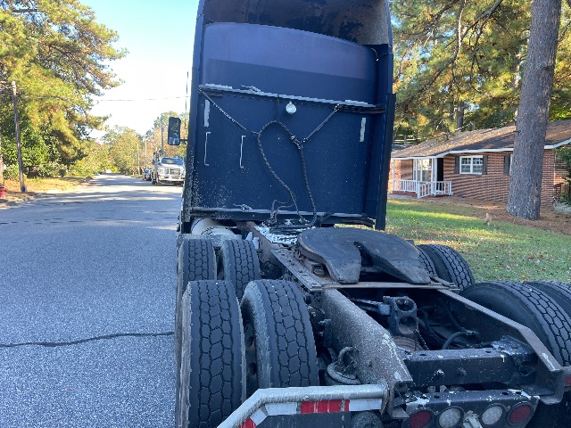 Kenworth truck chassis with fifth wheel and rear wheels visible; text on components not clearly legible.