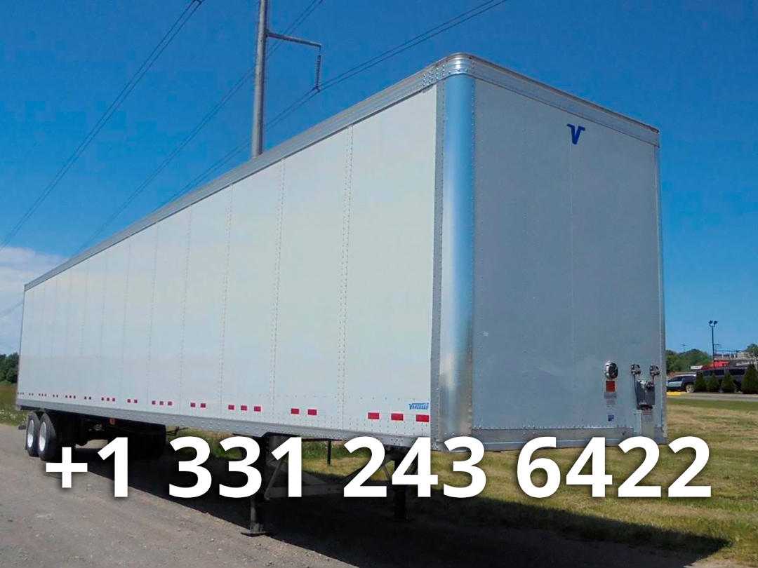 Vanguard dry van trailer side and front corner showing smooth white panels and V logo on front corner.