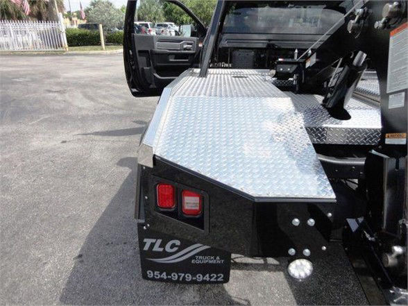 Ram 4500 HD tow truck rear with diamond plate toolbox and TLC Truck & Equipment branding.