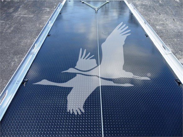 Truck bed with diamond plate and bird graphic on the surface, rear view showing seamless joint line and metal edges.