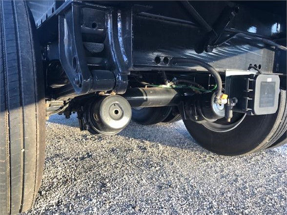 Underbody view of Fontaine Velocity steel trailer showing suspension components and axle with tag/box; no legible text identified.