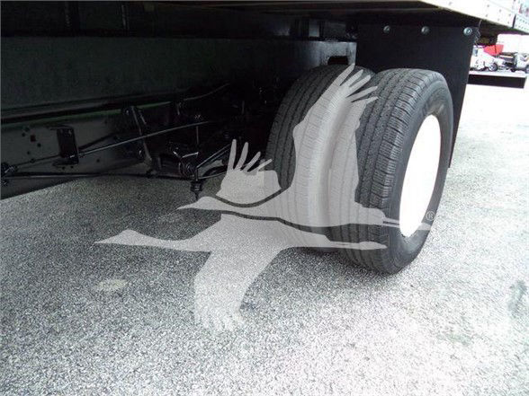 Rear axle area of a 2011 Ford E450 box truck showing dual rear tires and undercarriage components.