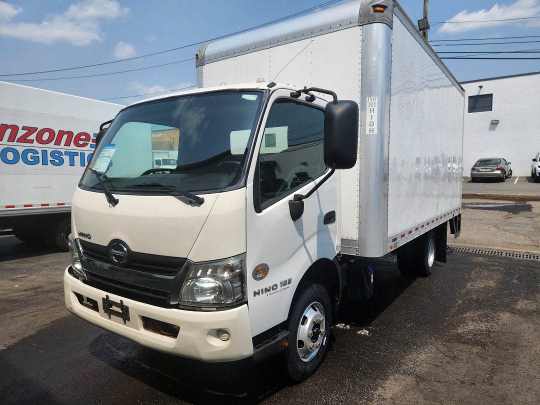 Box truck with white cab and cargo box showing Hino emblem, HINO 155 badge, and 1550  (text on side).