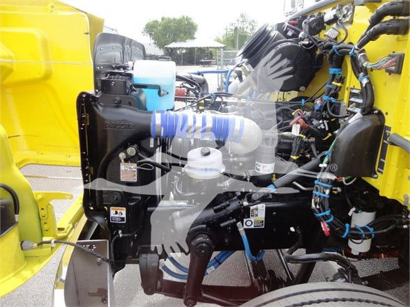 Peterbilt 337 engine bay showing coolant reservoir and various hoses and components.