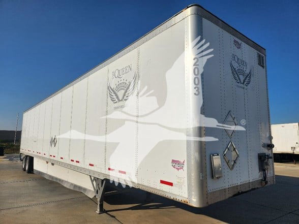 2018 Wabash trailer showing side and rear with Queen logo and phoenix emblem; VIN 1JJV532D5JL044429 visible on rear; stock number 5318133; aluminum box trailer.