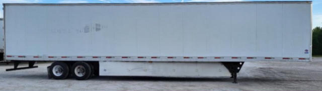 Utility trailer side view with white rectangular box and tandem axles; no legible labels visible on the side.