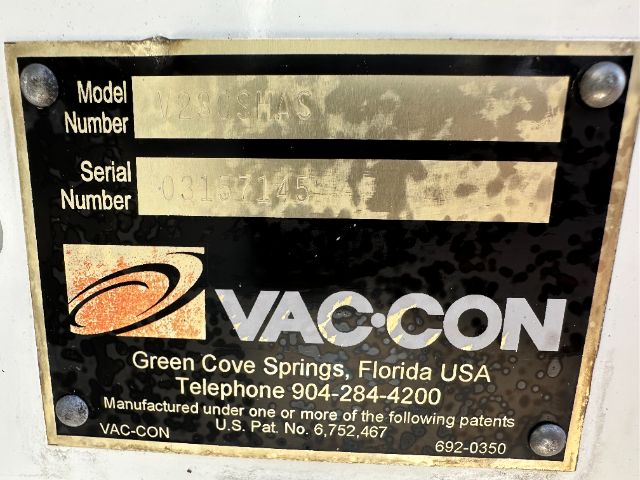 Label plate on Vac-Con equipment showing Model Number and Serial Number fields with VAC-CON branding and contact information.