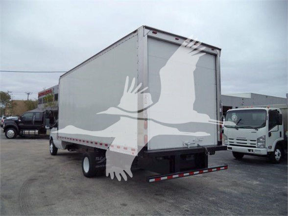 Box truck rear view with white curtain-style overlay; no legible labels or serials visible on the door or bumper.