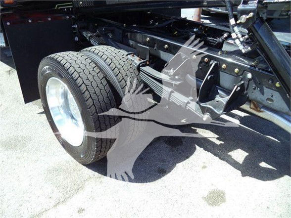 Ram truck rear wheel and suspension components showing dual rear tires and chassis frame.