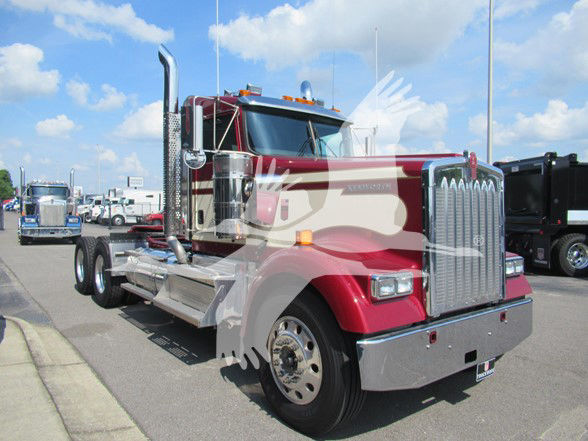 Kenworth W900L conventional daycab truck in red with chrome grille and exhaust stacks, front left view.