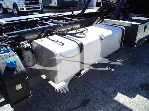 Isuzu FTR fuel tank and chassis area showing large rectangular tank with filler cap and hoses in a truck trailer setup.