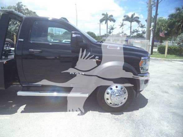Black 2024 Ram 5500 SLT pickup truck side view showing extended cab, chrome wheel, and side step. Overlay watermark obscures center.