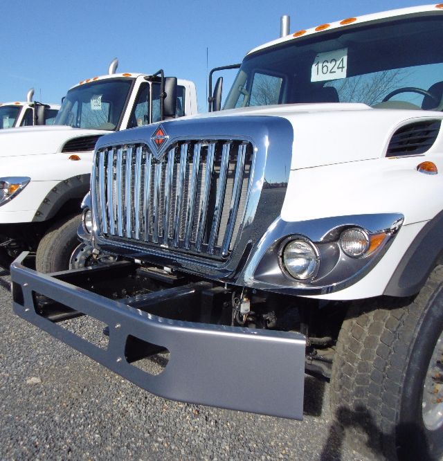 International truck from front-left angle showing chrome grille, bumper guard, and headlight assembly.