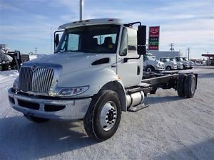 International 4300 cab and chassis showing front grille and cab in daylight.