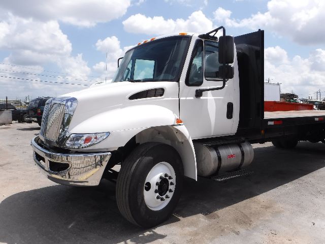 2018 International 4300 flatbed truck side view showing front cab and dump bed.